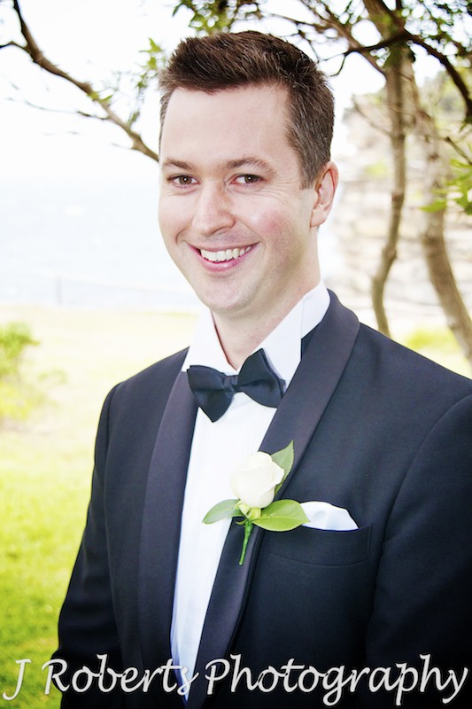 nervous groom smiles before ceremony starts - wedding photography sydney